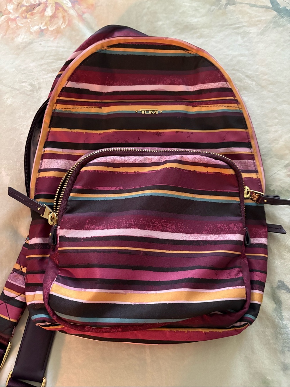Tumi Women's Striped Burgundy Multi Backpack with Gold Hardware
